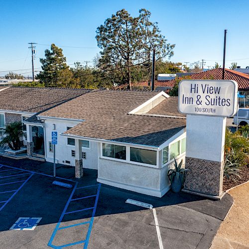 A single-story hotel called Hi View Inn & Suites with a parking lot and accessible parking spaces.